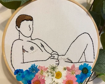 trans man in flowers on a crossstich circle